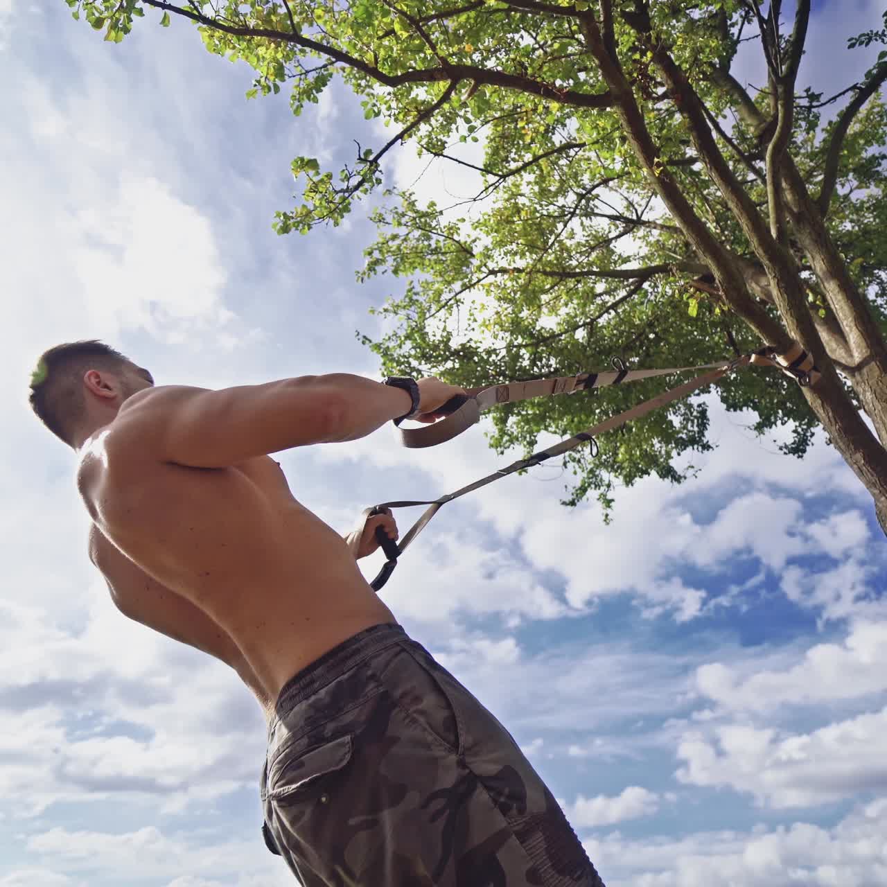 . Man exercising in park. Fitness man doing fitness exercises outdoor