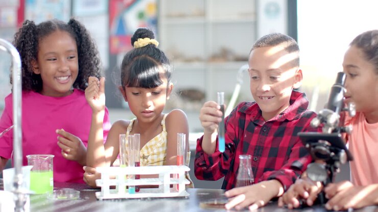 In a school classroom, a diverse group of young students engages in a chemistry experiment