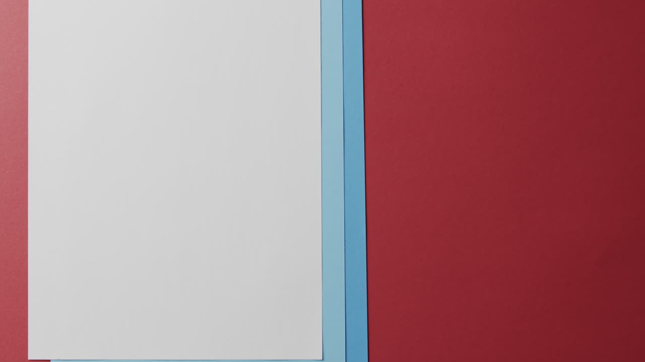 Close up of blank and blue cards on red background with copy space in slow motion