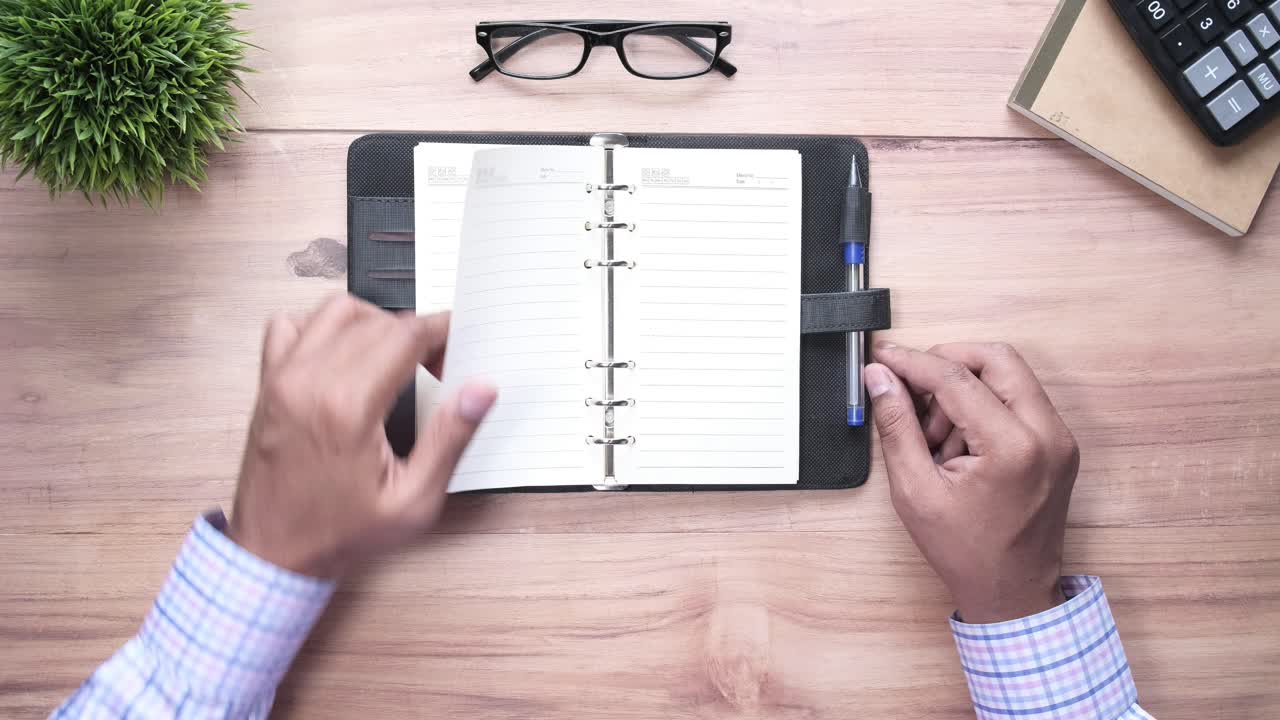 Person working on a notebook at a desk