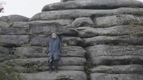 person standing amongst large rocks