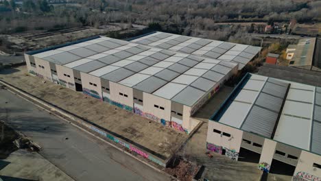 large industrial warehouses with graffiti near abrera, barcelona, spain, aerial view