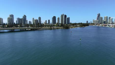 Stunning-Surfers-Paradise-from-the-air,-Descending-shot-ending-with-tree-and-foreshore