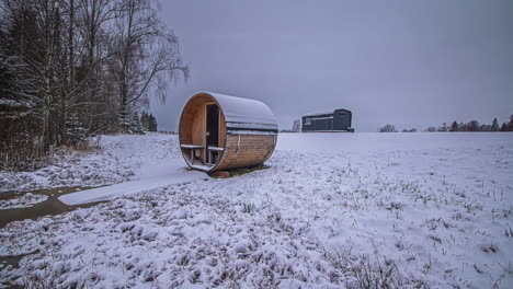 Time-lapse-of-same-nature-scene-outdoors-with-wooden-cabin-and-barrel-sauna-with-changing-light-and-colors-to-reflect-different-seasons