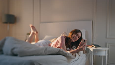 happy female talking online conference at home. smiling woman holding smartphone