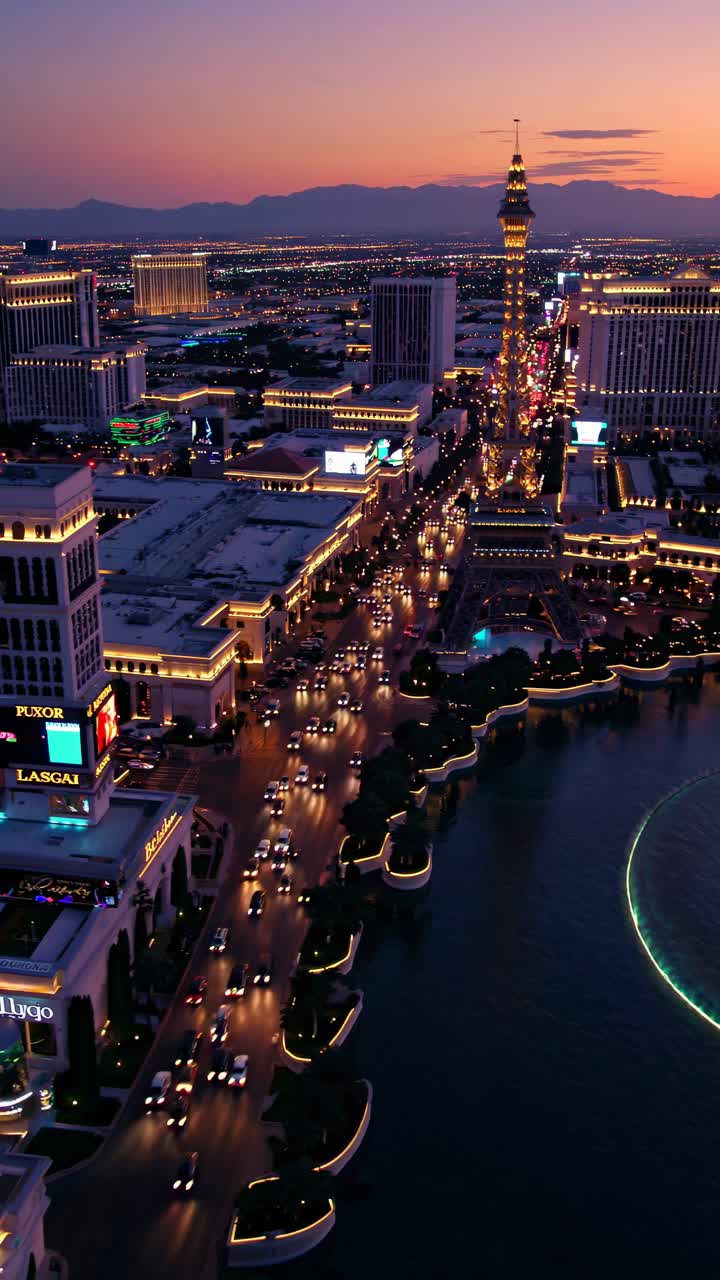 Aerial view of a vibrant cityscape at dusk, showcasing illuminated streets and buildings