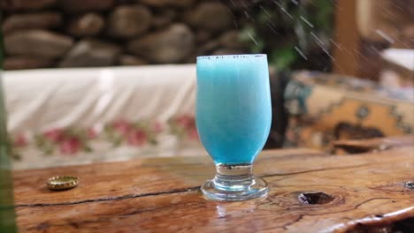 refreshing blue beverage in a rustic setting