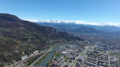 european scientific centre grenoble aerial drone view, snowy mountains in back