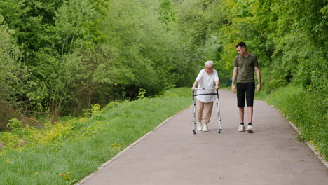 young man assisting elderly woman in park