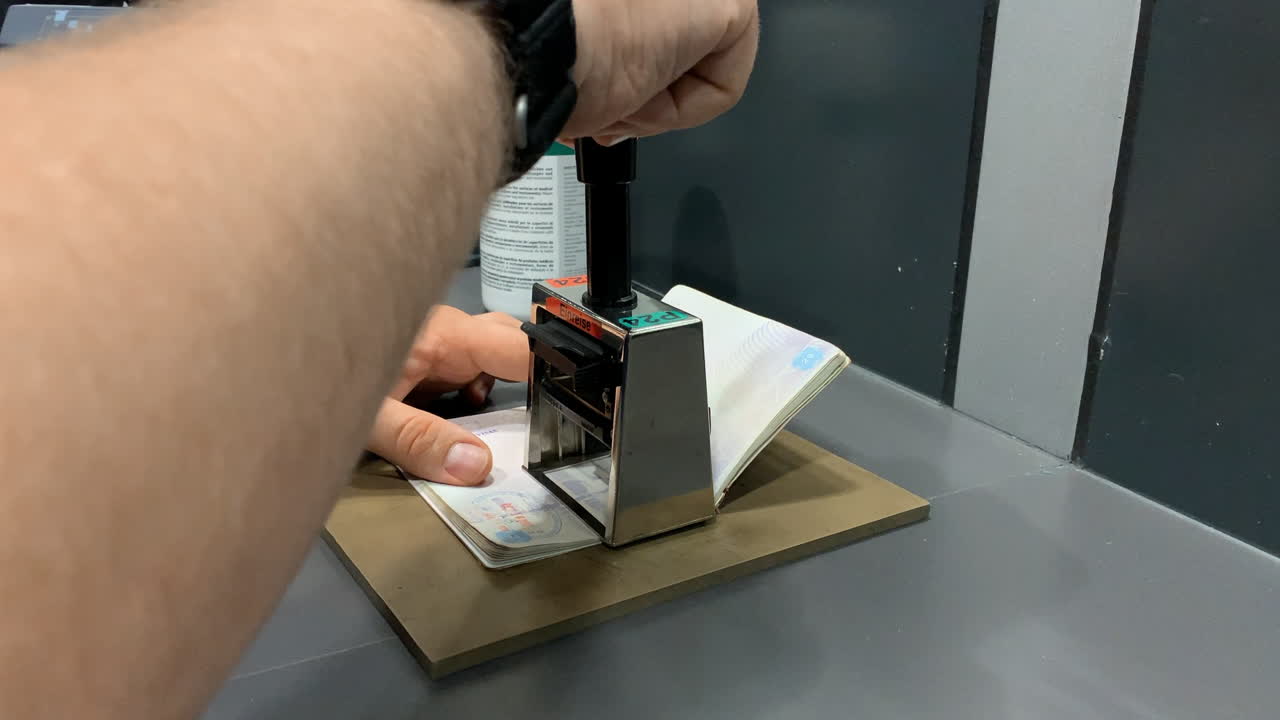 Officer makes a stamp in a passport at the Airport, Border Control.