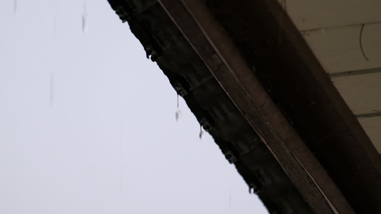 falling rain from the roof during raining season. feeling lonely