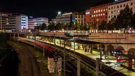 copenhagen night timelapse: railway tracks in central urban landscape