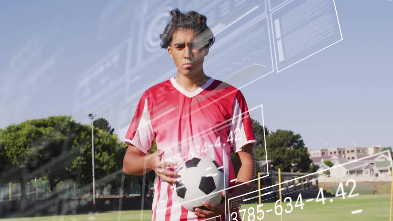 Holding soccer ball, athlete on field with animation of digital data overlay