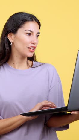 surprised woman looking at laptop screen