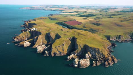 St-Abbs-Head's-Lighthouse-and-Rugged-Cliffs:-An-Aerial-Journey-of-Rocky-Coastline,-Scotland,-United-Kingdom