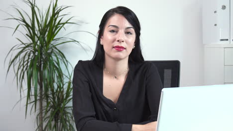 atractive female office worker nodding to the camera