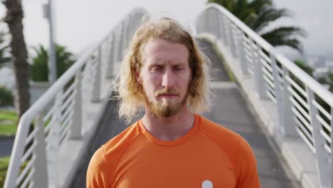 sporty caucasian man on a bridge