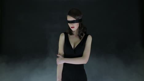 woman in black dress with blindfold