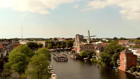 Aerial-Establishing-shot-of-Haarlem-Windmill-De-Adriaan,-Netherlands