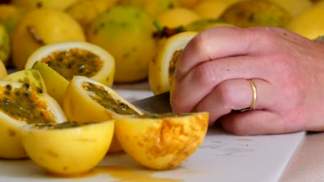 cutting passion fruit on a chopping board