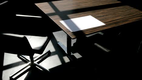 shadows drift over office furniture, time lapse