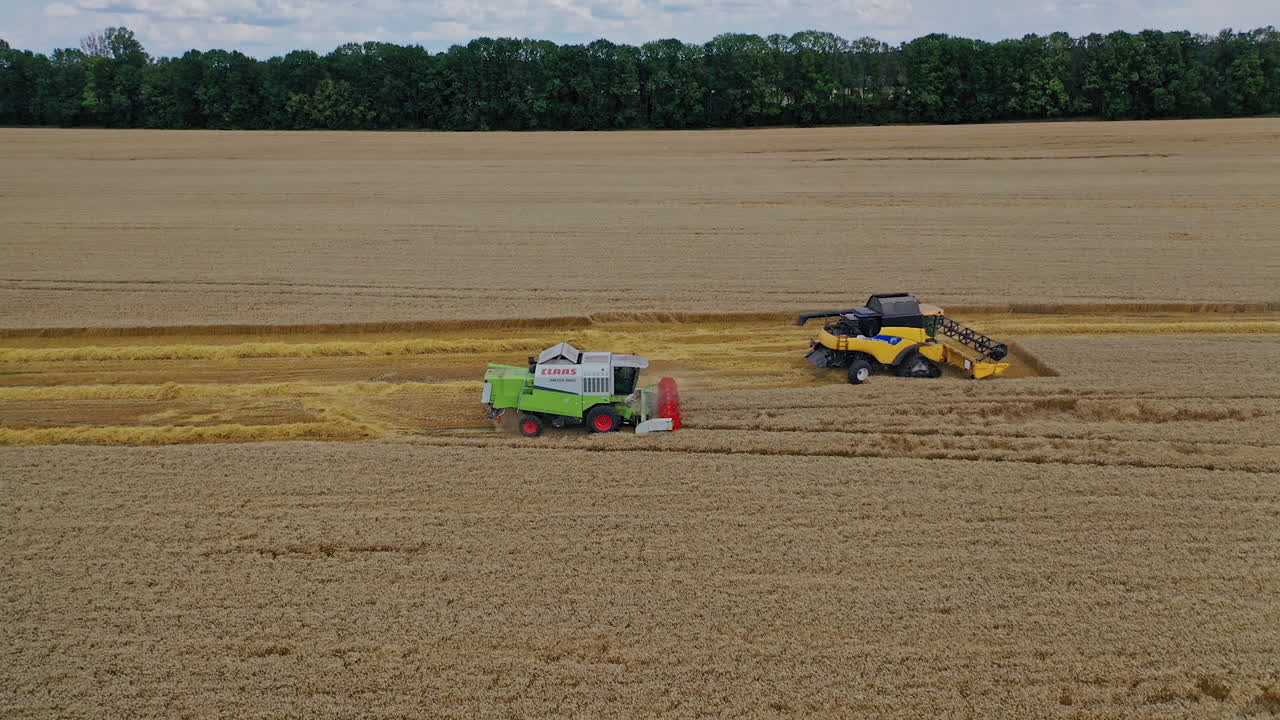 Combine harvester on field wheat. Aerial shot of combine harvesters working on field