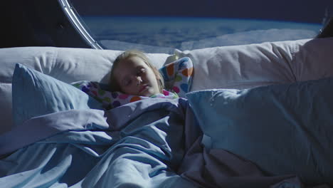 child sleeping in space bed