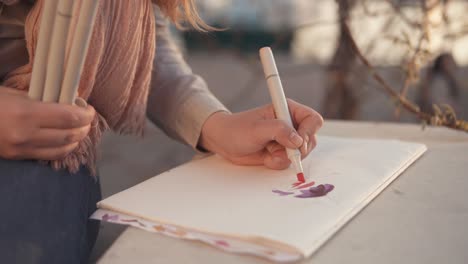 woman drawing flowers outdoors