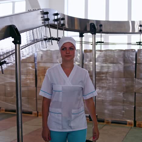 modern plant for oil production. female worker switches on automated equipment inside the factory. new technologies in food industry.