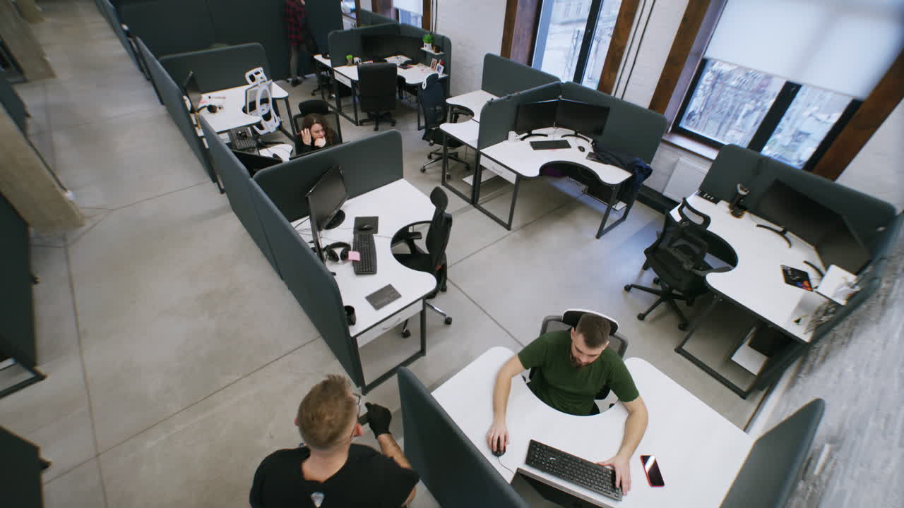 Overhead view of people working in a modern office with cubicles ...