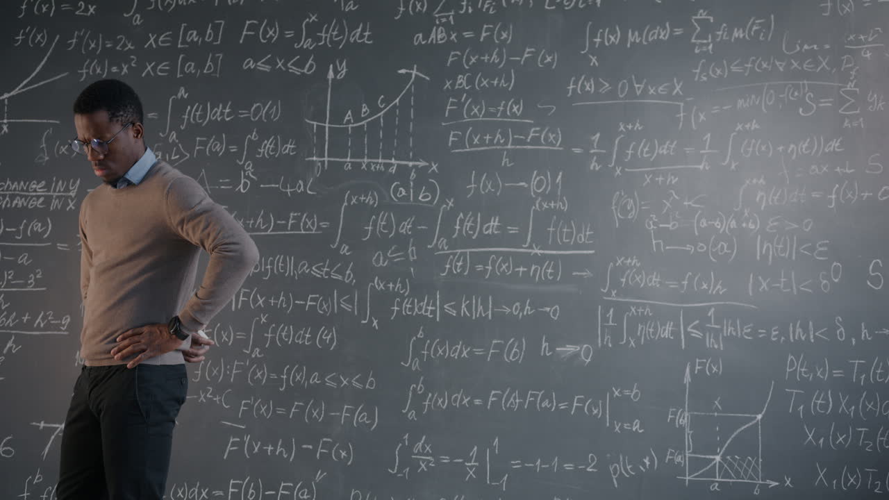Man Explaining Math on a Chalkboard