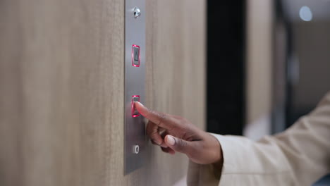 person pressing elevator button