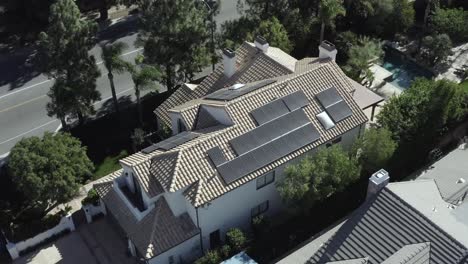 modern luxury house, residential neighborhood, home with solar panels, aerial drone view