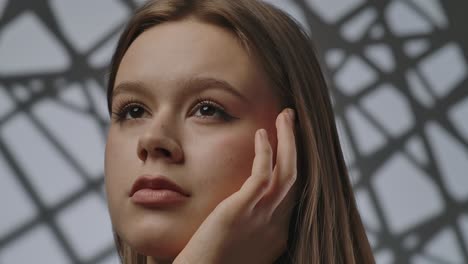 elegant portrait of a woman with dramatic lighting and expression the woman looks to the side with her head resting on her hand in dramatic lighting that perfectly emphasizes her facial expressions and features