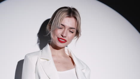 smiling woman in white blazer