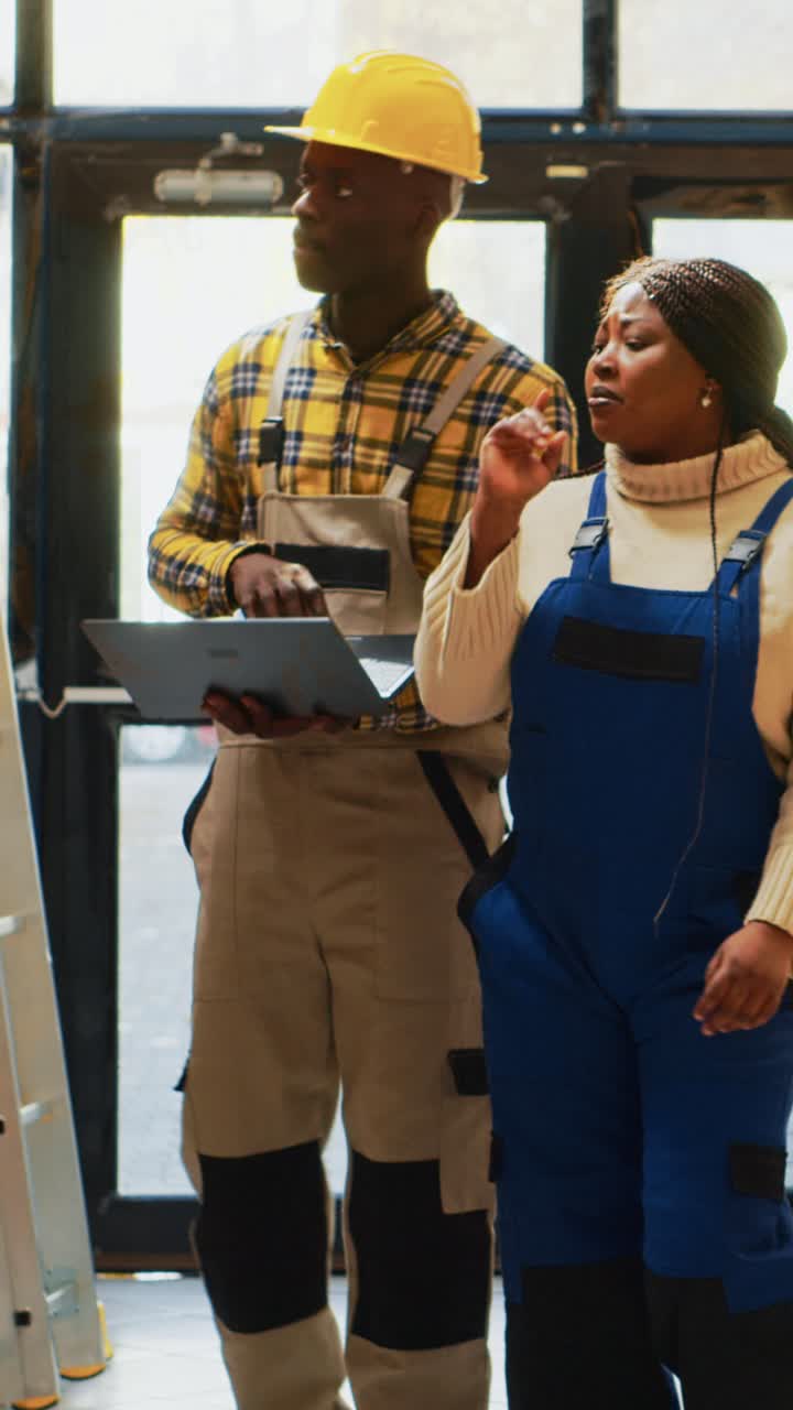 Vertical video: African american people using laptop to do inventory