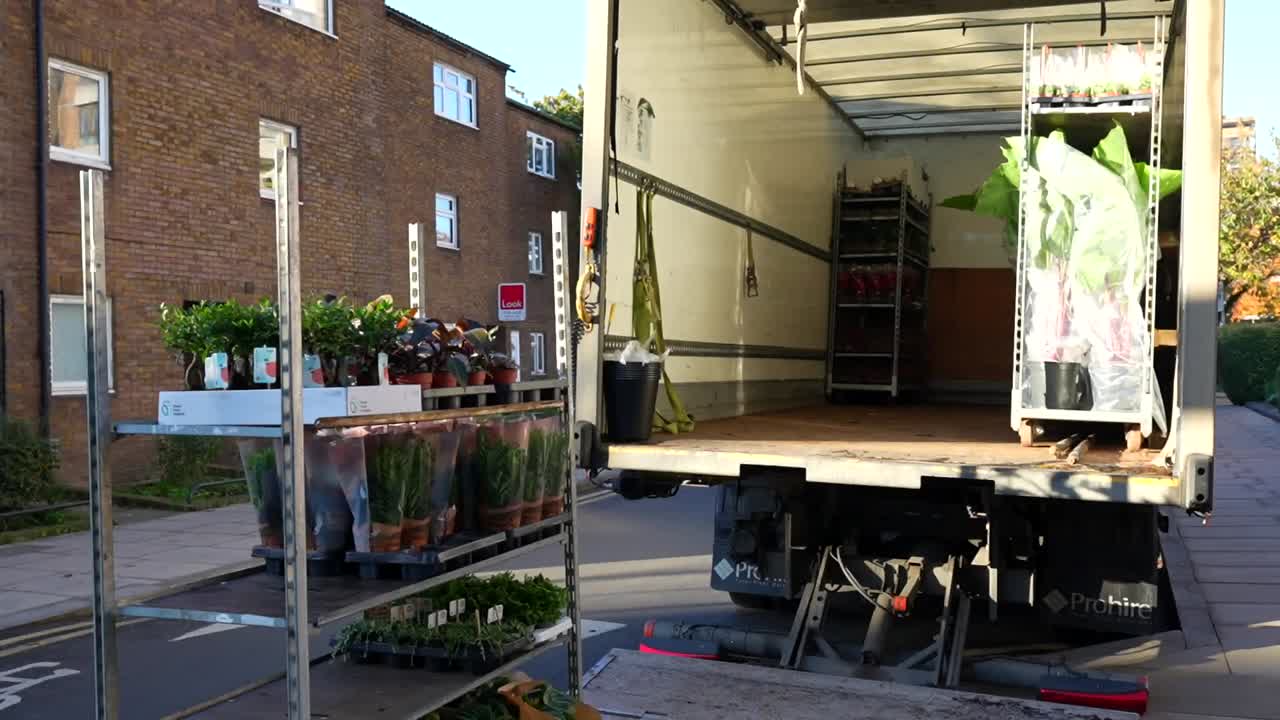Truck with an open tailgate while unloading the plants for the market on Columbia Road, London