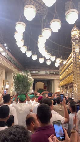 muslim pilgrims offering flowers at a mosque
