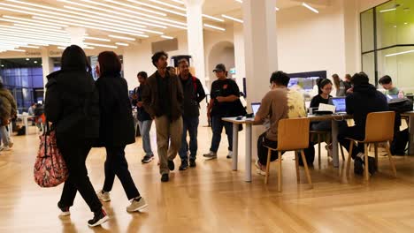 people walking and studying in library