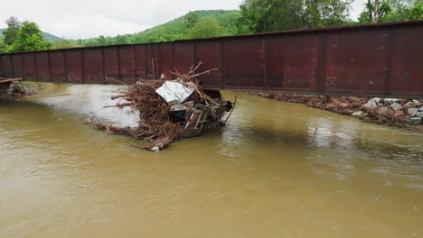 debris and trees pinned against railroad bridge in 2023 flood-hit vermont