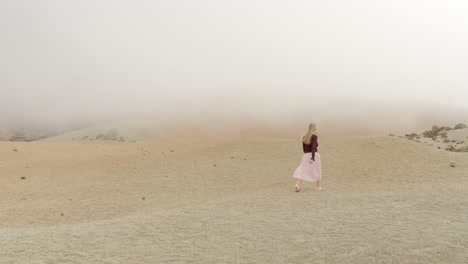 Woman-walk-in-Teide-national-park-on-foggy-day,-out-of-this-world-scene