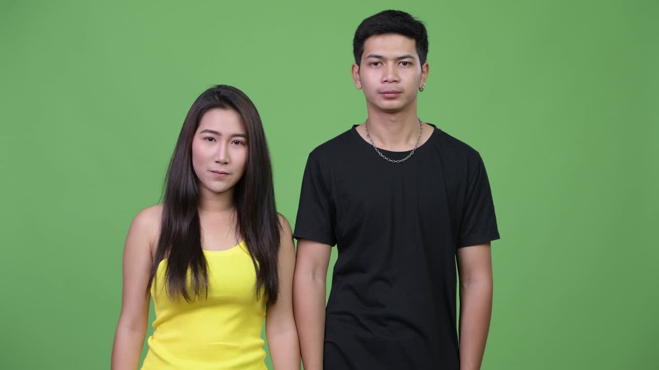 Young Asian couple with arms crossed together