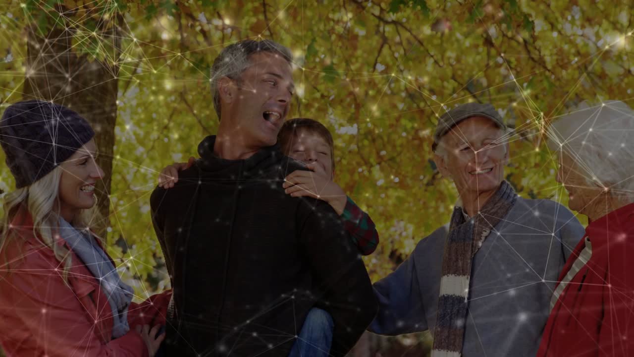 Man carrying child under tree, turning head causing laughter, white nodes overlaying family tech