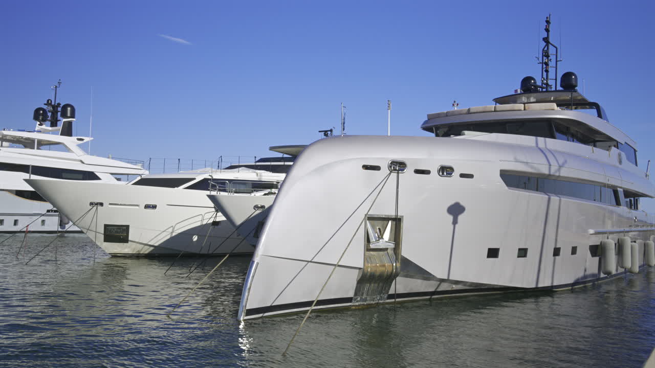 Large yachts docked in the Cannes harbour in daylight in France