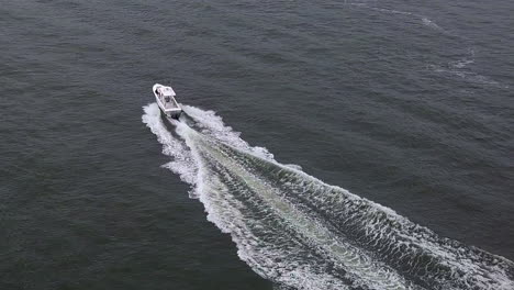 Boat-driving-in-NYC-river-with-NYC-skyline-in-background