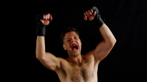 excited male boxer posing after victory