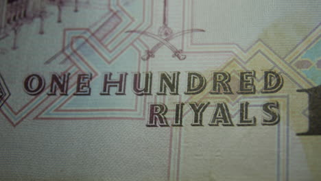 this is the macro view of a normal paper bank not- money- currency ofsaudi arabia 100 riyals bill