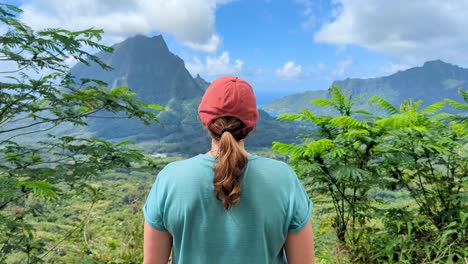 woman enjoying a scenic view of mountains and ocean