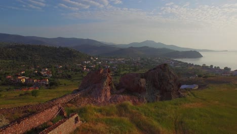 Aerial:-A-rock-on-top-of-a-hill-on-Lesbos-island,-Greece