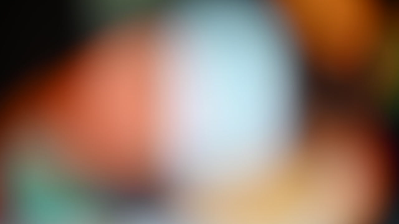 Abstract blurred background with vibrant red, orange, and white hues